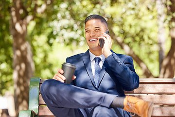 Image showing Businessman, phone call and coffee talking on bench outdoor in morning for online conversation, virtual meeting or relax happy on corporate break. Man, sitting on bench and speaking on mobile in park