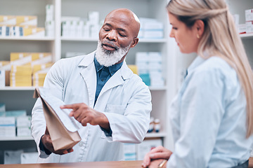 Image showing Pharmacist, medicine and help for woman customer at the counter for pills, help and information on treatment. Pharmacy, consulting and girl asking questions from healthcare worker, advice and trust