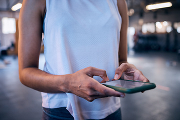 Image showing Woman, hands or phone typing in gym for workout management app, fitness subscription or exercise healthcare data. Zoom, sports athlete or personal trainer on mobile technology for social media blog