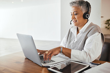 Image showing Call center, receptionist and senior consultant working on a laptop, headset and tablet in the office. Customer support, hotline and elderly female telemarketing agent typing on computer in workplace