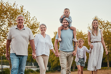 Image showing Nature, portrait and big family on a walk in the park for fresh air, exercise and adventure. Grandparents, parents and children walking together and holding hands in an outdoor garden in Australia.