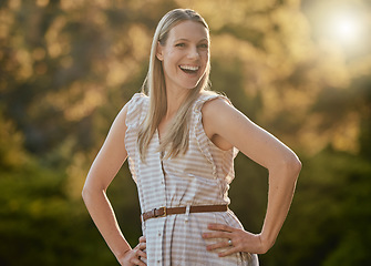 Image showing Portrait, happy and woman relax in park, smile and cheerful while walking in nature, fresh air and joy. Face, girl and adventure in forest, excited and having fun, pose and laugh on bokeh background