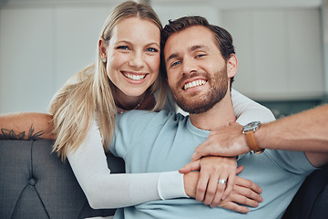 Image showing Couple, sofa and portrait for hug, smile and love for romance, relax and holding hands in living room. Happy couple, man and woman with embrace by couch, lounge and happiness at house in Los Angeles