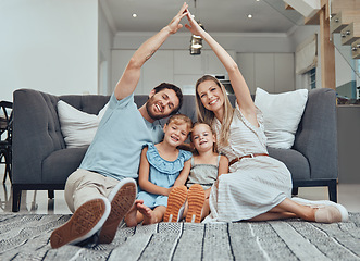 Image showing Family home, portrait and roof hands with smile, parents and happiness by sofa in living room together. Young happy family, kids and floor with love, bonding and care on lounge carpet in Los Angeles