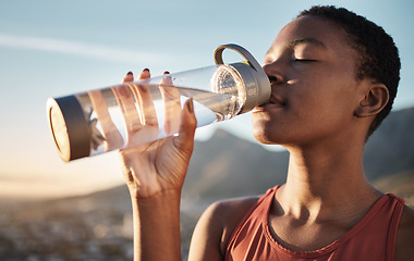 Image showing Fitness, black woman and drinking water bottle after training workout, exercise and outdoor cardio running. Thirsty young athlete, sports hydration and nutrition for wellness, healthy body and energy