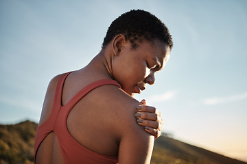 Image showing Shoulder, black woman and exercise injury from outdoor sports training on sky background. Athlete, arm and joint pain, muscle problem and first aid emergency from wound, fitness and workout mistake