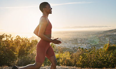 Image showing Fitness, sunset and profile of running black woman training for USA marathon race, cardio workout or body health goals. Blue sky flare, nature and runner exercise in Los Angeles Hollywood mountains