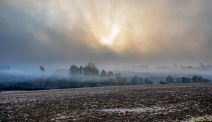Image showing Autumn foggy and misty sunrise landscape
