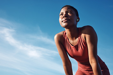 Image showing Black woman, exercise or tired after training, running or workout for balance, wellness or health outdoor. Sky, African American female, runner or athlete relax, breathing or focus for cardio or rest