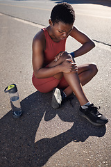 Image showing Fitness, knee and black woman injury, after training and workout with agony, emergency and outdoor. African American female, runner and athlete with pain, suffering and discomfort on road and hurt.