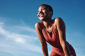 Image showing Fitness, black woman and happy athlete smile after running, exercise and marathon training workout. Blue sky, summer sports and run of a African runner breathing with happiness from sport outdoor