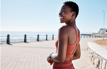 Image showing Fitness, black woman and running by the sea in summer with happiness for exercise and workout. Smile, health wellness and ocean runner in the morning sun with freedom happy about training and sport