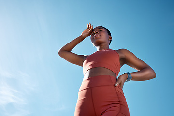 Image showing Black woman, tired or sweating in fitness workout or training exercise on blue sky background in healthcare wellness. Low angle, runner or sports athlete exhausted, fatigue or marathon challenge done