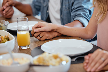 Image showing Holding hands, praying and food with a family grace around the dinner table during a thanksgiving celebration. Prayer, trust and love with a group of people enjoying lunch during a social gathering