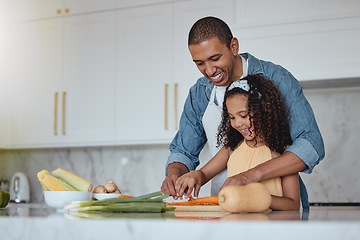 Image showing Love, father and girl cooking food with healthy vegetables for lunch or dinner meal as a happy family at home. Nutrition, smile or dad teaching or helping a young child cut carrots on kitchen counter