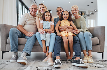 Image showing Love, interracial and family on sofa, grandparents and children relax, portrait and happy together. Grandmother, grandfather and girls with mother, father and bonding in living room, smile or weekend