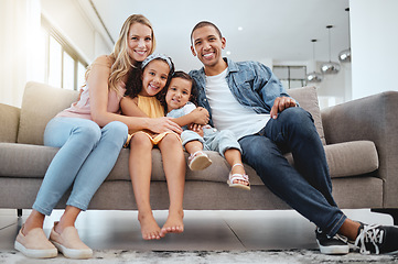 Image showing Interracial, portrait and family on sofa, love and bonding on weekend, break and smile together. Multiracial, man and woman with daughters, kids and in living room for quality time, happy and couch.