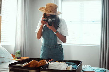 Image showing Photography, travel luggage and woman with camera shooting suitcase clothes for summer vacation. Home bedroom, memory picture and photographer girl going on global holiday, adventure journey or trip
