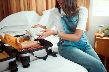 Image showing Travel, suitcase and woman packing in bedroom preparing for vacation, holiday or trip. Luggage, clothing and female tourist on bed getting ready for journey, traveling and break or getaway in home.