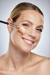 Image showing Portrait, beauty woman and foundation color for skincare or cosmetics dermatology and facial wellness in studio. Happy model, apply luxury makeup and face products or glowing skin with brush
