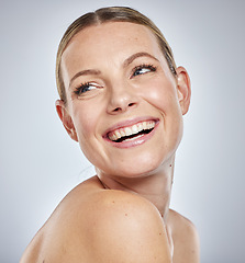 Image showing Face, beauty skincare and woman in studio isolated on a gray background. Thinking, cosmetics and happy female model in makeup smiling after spa facial treatment for healthy, glowing and flawless skin