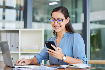 Image showing Business woman, laptop and smile for phone, communication or reading at the office. Happy female employee event planner checking email, social media or post on smartphone and computer at workplace