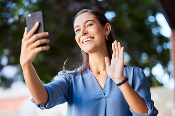 Image showing Woman, phone and hand wave during video call with business contact for communication with a smile and happiness outdoor in city. Female outdoor on zoom greeting hello while talking with 5g network