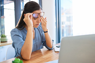 Image showing Woman headache, office and tired with laptop, glasses and fatigue of eyes, pain or stress at workplace table. Finance expert, rest and burnout at desk, computer and modern office in city of New York