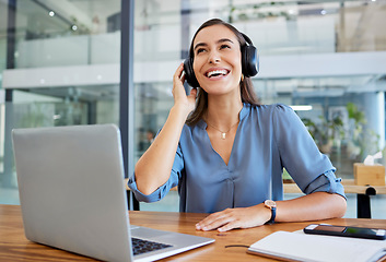 Image showing Music, headphones and business woman in office streaming radio or podcast. Break, thinking and happy female employee from Canada on desk with laptop listening to song, audio or sound at workplace.