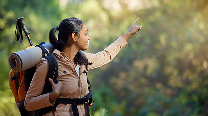 Image showing Hiker, exercise and backpacking with a woman in nature for adventure and carefree freedom. Backpack, hiking and view with a female pointing while in a forest to hike while on a natural environment