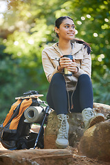 Image showing Hiking, woman and drinking coffee while on a backpacking break in the forest during a hike. Hiker, female and tea drink for freedom and carefree adventure in the woods for sport and active lifestyle