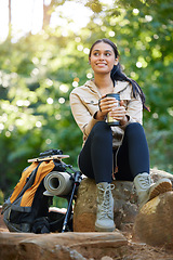 Image showing Nature, relax and hiking woman drinking coffee on rock on adventure trail with trees. Health, fitness and freedom, happy woman in forest or jungle in Brazil sitting on rocks with smile and backpack.