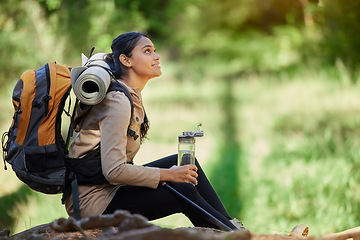 Image showing Black woman, hiking and rest sitting in nature, woods or forest for goal, motivation or outdoor adventure. Woman hiker, water bottle and tired on trail for wellness, fitness or trekking in California