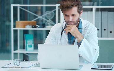 Image showing Doctor, scientist and laptop with a man reading and thinking while doing medical research on database or data analysis at desk. Healthcare worker with technology for internet. search and innovation