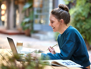 Image showing Woman, laptop and student study at cafe with smile for education, learning or writing in the outdoors. Happy female at internet coffee shop in remote working or elearning on computer for assignment
