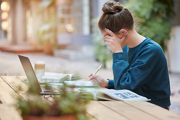 Image showing Woman, student and writing in study for elearning, education or working with laptop and books at an outdoor coffee shop. Focused female studying remote with notebook for assignment at outdoor cafe