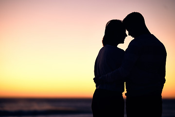 Image showing Couple, silhouette and sunset at beach for love, care and romantic date together with mockup on horizon sky. Shadow of man, woman and people hug at sea for travel, honeymoon vacation and calm holiday