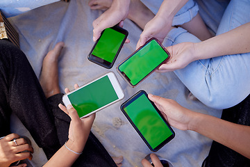 Image showing Top view, hands or people with green screen phones for social media app, internet esports game or music sharing software. Men, women or friends with mock up technology space on bonding beach picnic