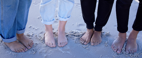 Image showing Beach feet, friends and people on vacation, holiday or summer trip. Toes, freedom and group of men and women standing on sandy seashore, seaside or coast, having fun or enjoying quality time outdoors