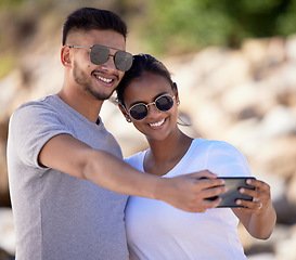 Image showing Couple, smile and selfie on summer vacation, holiday and travel adventure together with love, care and happiness. Happy couple, man and woman with sunglasses taking mobile photo outdoor for memory
