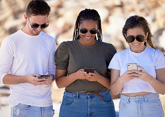 Image showing Friends, group and texting with phone, sunglasses and happy on travel, adventure or holiday in nature. Gen z people, smartphone and social media communication for happiness, vacation and app in Cairo