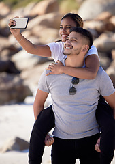 Image showing Beach, selfie and piggy back couple, smile with smartphone on romantic summer holiday at ocean. Romance, man and woman at with phone, love and vacation time for happy couple together in Australia.