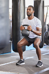 Image showing Black man, gym and kettlebell for squat exercise, weightlifting workout or muscle growth training. African bodybuilder, wellness trainer and metal weights for strong legs, body development or health