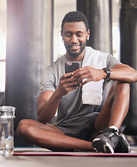 Image showing Fitness, phone and black man relax and smile for online communication, sports workout or watching exercise tutorial in gym. Happiness, training wellness video on mobile and rest after cardio run