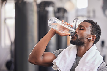 Image showing Water bottle, tired black man in gym and resting after fitness workout, healthy sports exercise and muscle growth training. Rest, motivation and thirsty athlete drinking water for hydration wellness