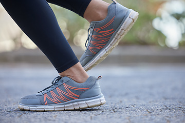 Image showing Legs, shoes and woman running on road for health, wellness and exercise. Fitness, sports and healthy female athlete with sneakers training alone outdoors in town, street or city for race or marathon.