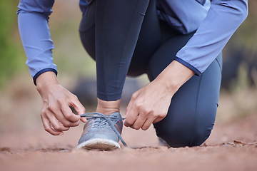 Image showing Start, running and feet of a woman in nature, training motivation and cardio fitness in Colombia. Ready, shoes and hands of an athlete tying laces for workout, exercise or hiking in a park for health