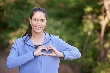 Image showing Cardiovascular, woman with hands in heart shape and fitness with health, running for cardio and exercise outdoor with portrait. Cardiology, runner and sport, run and mockup with cholesterol balance.