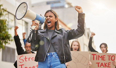 Image showing Protest, shouting and woman with megaphone in city marching for gender equality, justice and freedom. Demonstration, social change and crowd of people for human rights, free speech and and revolution