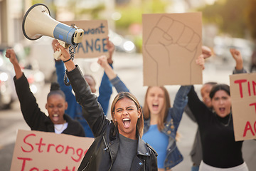 Image showing Woman, megaphone and fist in community protest for equality, human rights or economic change in the city. Angry women standing together marching in the street for strike, voice or billboard message